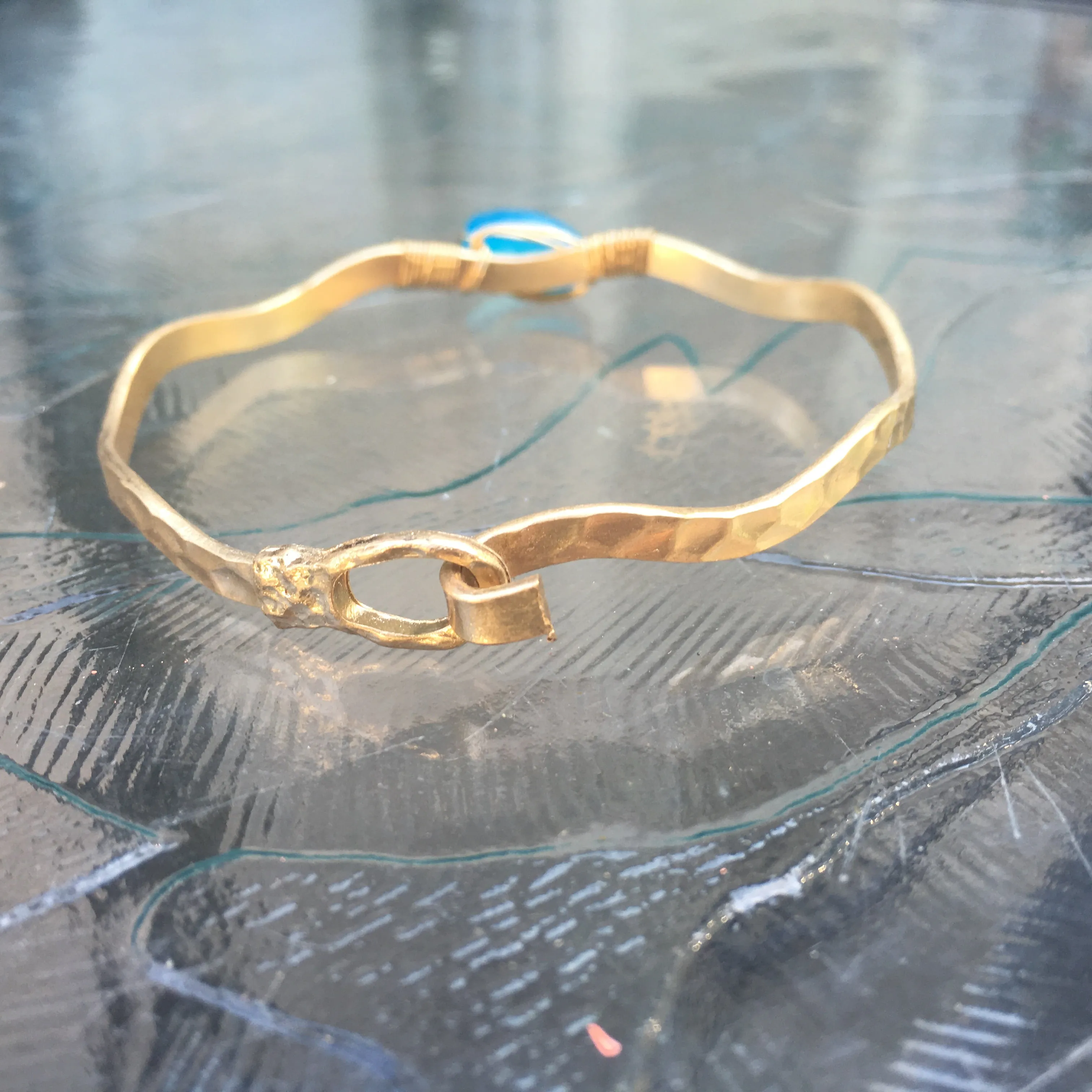 Worn Gold Tone Wavy Latch Bangle with Stone- Blue
