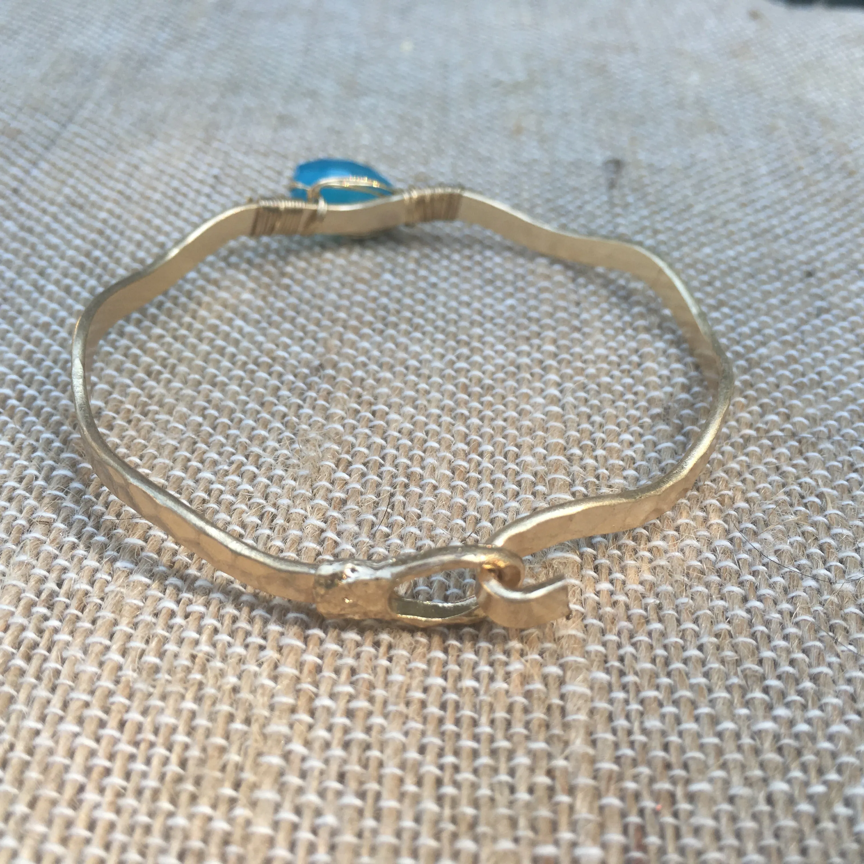 Worn Gold Tone Wavy Latch Bangle with Stone- Blue